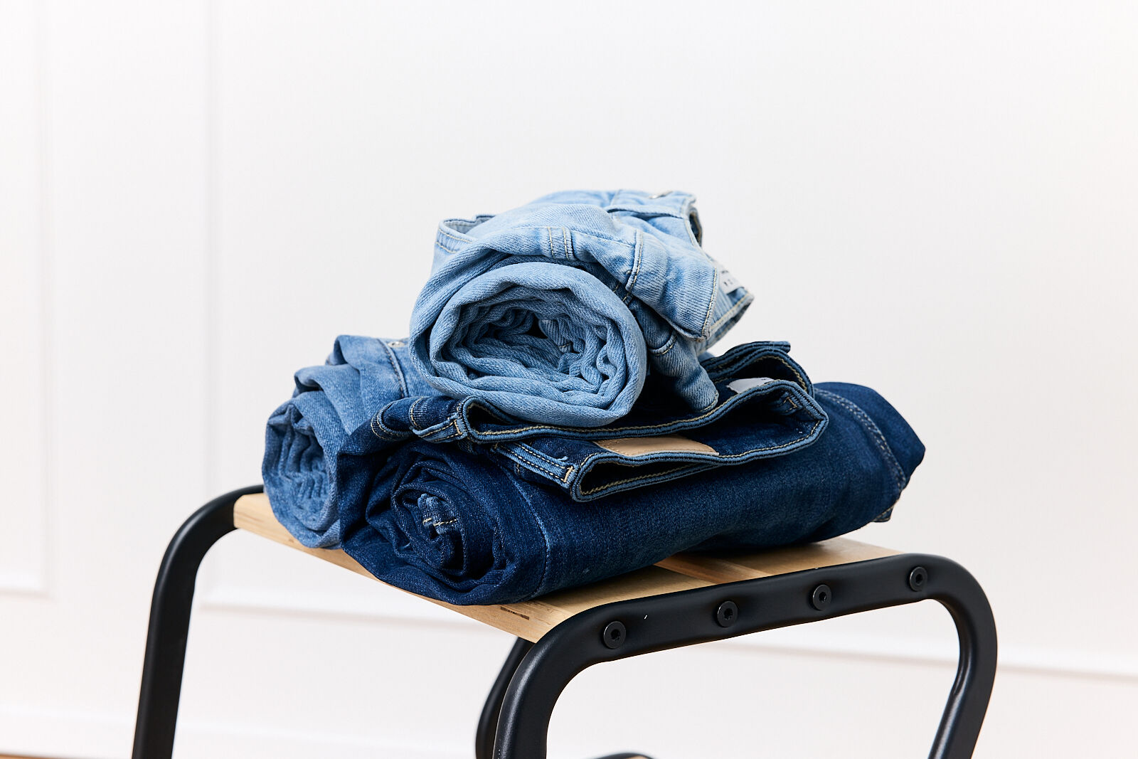 Jeans rolled up on a stool